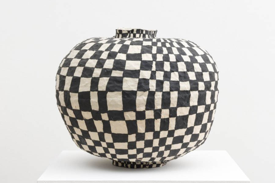 1. Brittany Mojo, Another Day, 2021, stoneware and underglaze with porcelain appliqué. Round, slightly squat vessel with black and white checkerboard pattern.