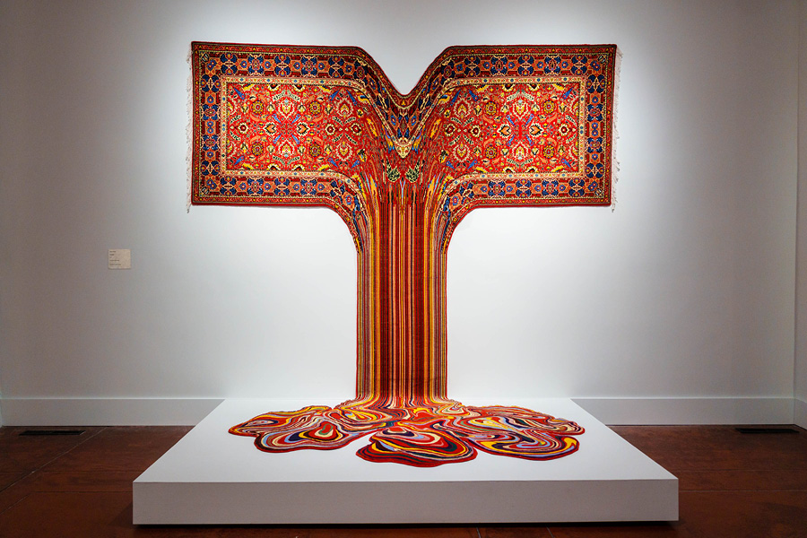 Artwork: traditional multicolored oriental carpet with the middle fabric dripping down into a puddle on the ground. Faig Ahmed, Gautama, 2017, Handmade wool carpet, 112" x 149"