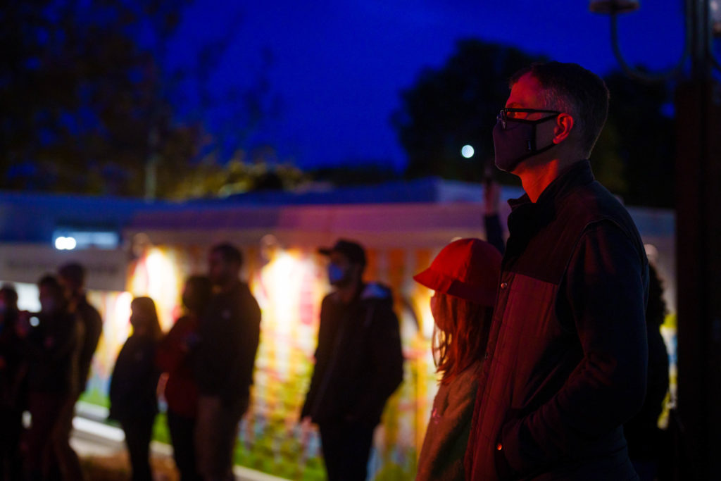 Masked individuals watch a performance of "Spira"