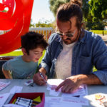 A father and son work on an art project at SLOMA's Second Saturdays event