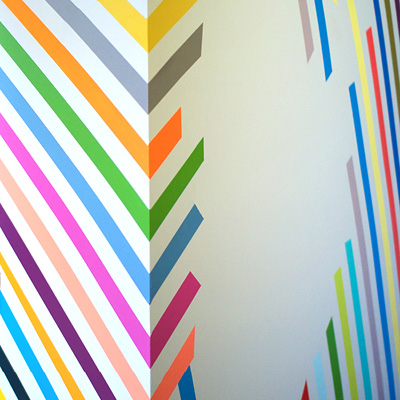 An example of Leah Rosenberg's art: colorful lines run parallel at a 45 degree downward angle, curving around a corner