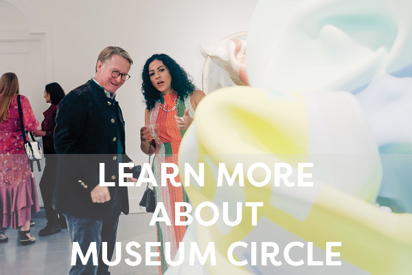 A museum circle member talks with an exhibiting artist about her work on view