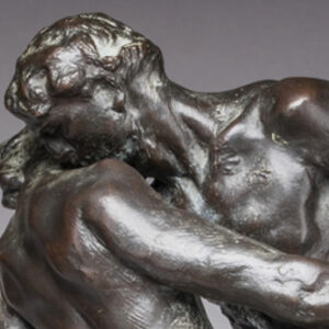 Detail of a bronze sculpture depicting a dancing couple, spinning together on a diagonal axis in a close embrace