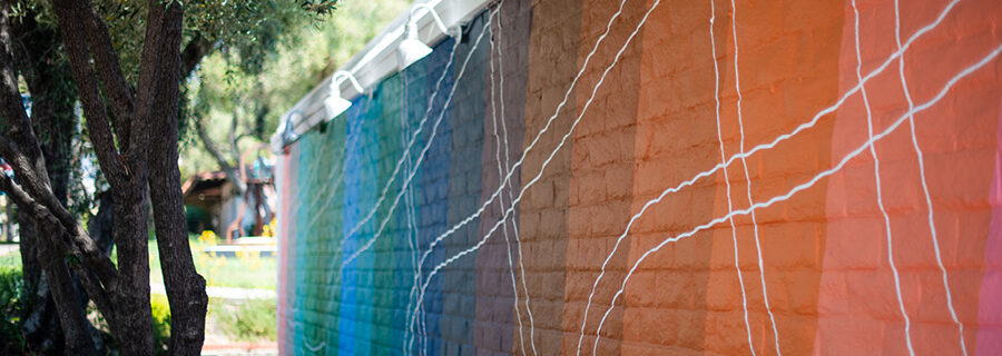 A mural depicting angled bands of primary colors broken up by a series of waving white lines