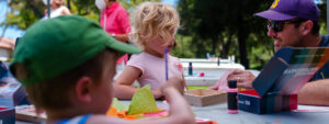 A young family completes an art activity at SLOMA