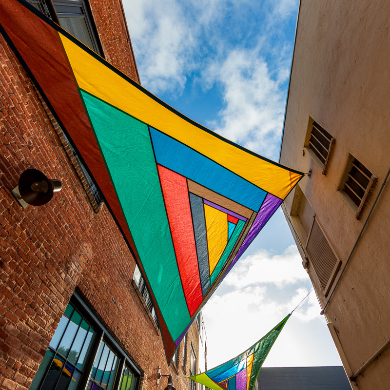 Along the Way, Rachel B. Hayes Underside photograph of a colorful sailcloth suspended overhead