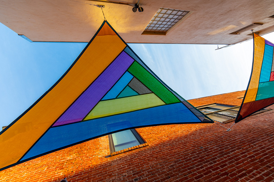 Underside photograph of a colorful sailcloth suspended overhead