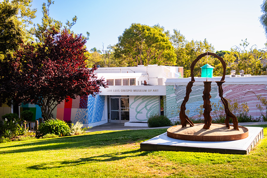 A steel sculpture reminiscent of a jellyfish with a teal resin 