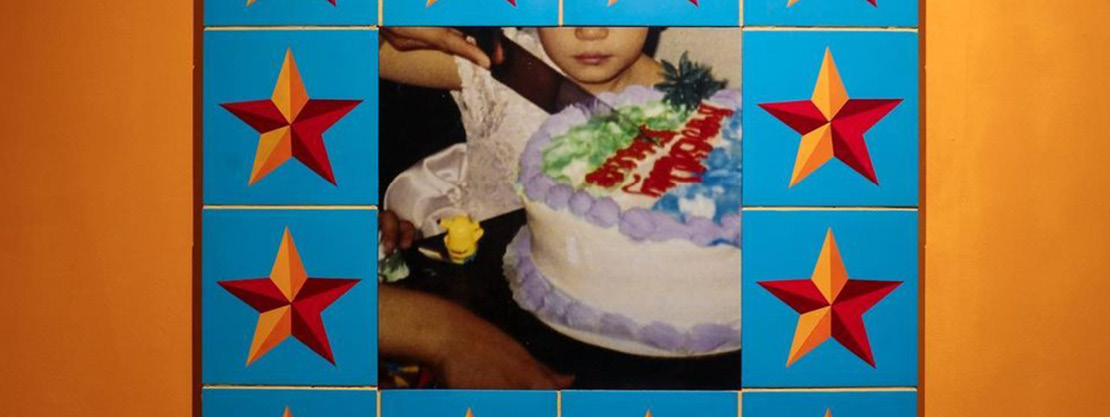 A faded family photograph of a child's birthday party surrounded by colorful star tiles