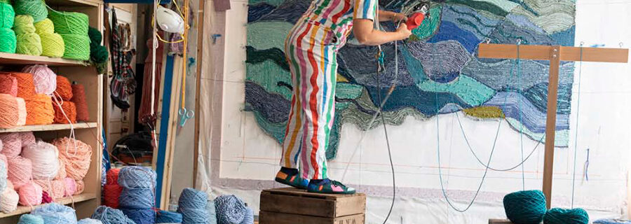 Artist Trish Andersen tufting a custom textile piece