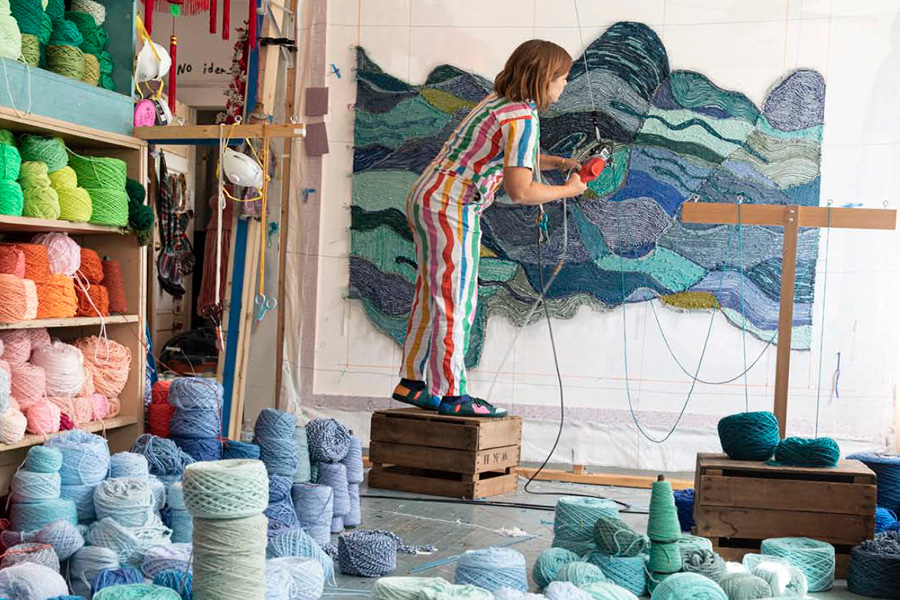 Artist Trish Andersen tufting a custom textile piece