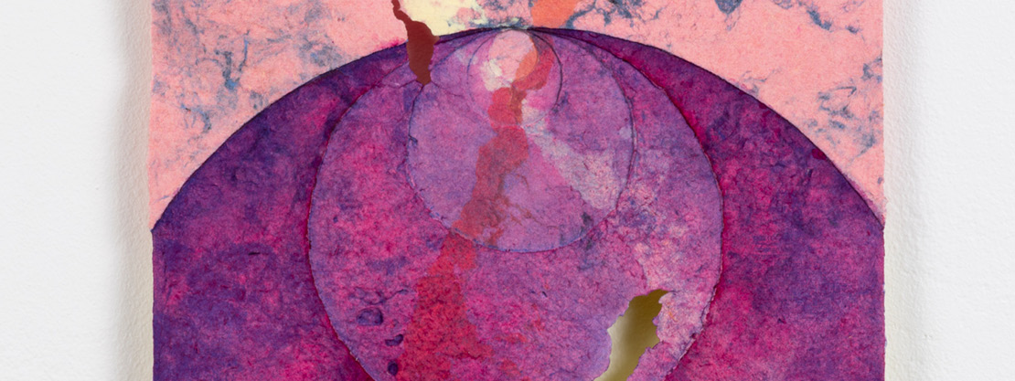 A recycled ragpaper sculpture comprised of concentric circles and side "wings" in pink