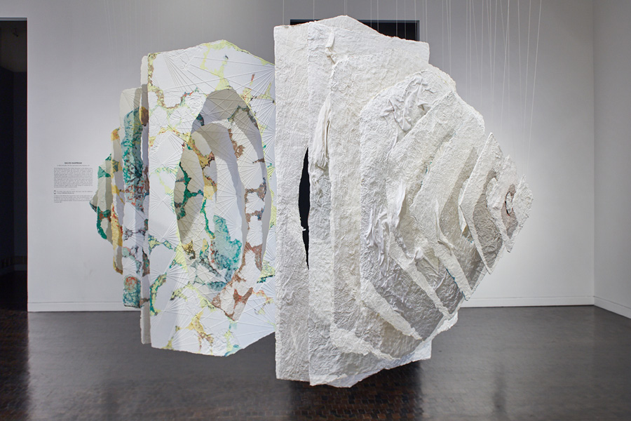 A hanging cone sculpture made of handmade recycled paper