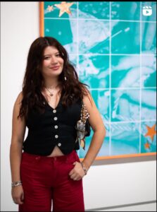 Deanna Barahona on Instagram Artist Deanna Barahona standing in front of her art