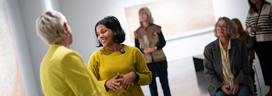 Two women leading a gallery tour