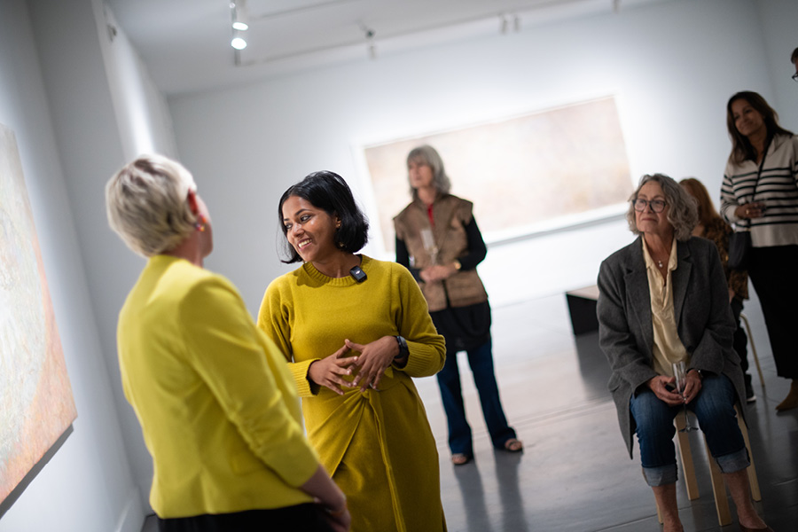 Two women leading a gallery tour