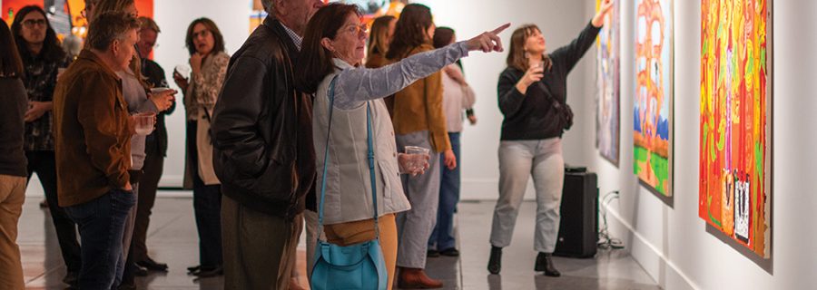 People in the gallery pointing at art. SLOMA logo and "Impact Report 2025" in white text